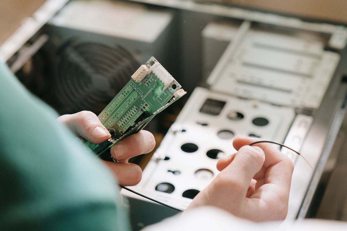 Technician installing memory in a desktop computer