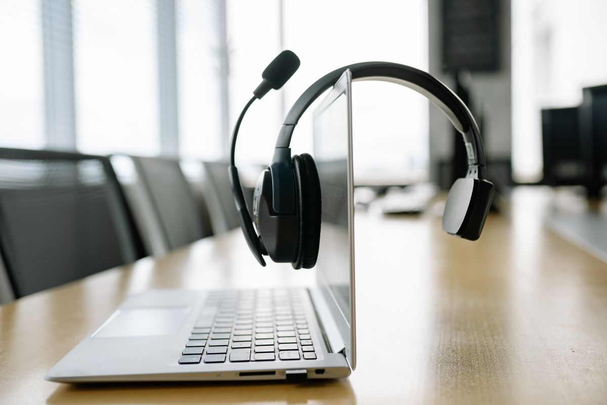 Headset resting on an open laptop